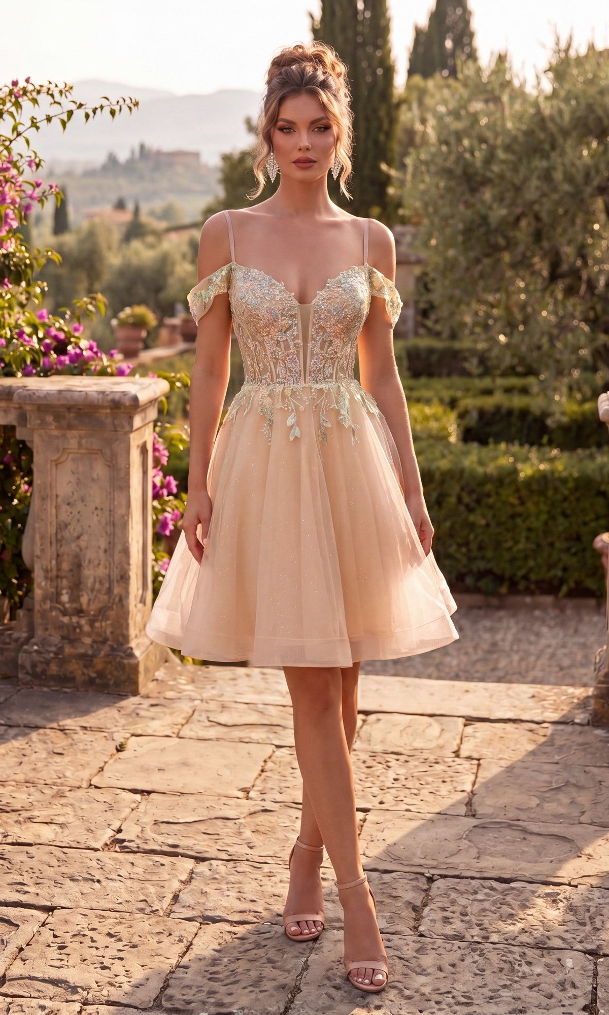 A woman stands outdoors on a stone path, wearing the Chicas C359 short homecoming dress in champagne, featuring an off-the-shoulder design with delicate floral lace appliques and a tulle skirt.